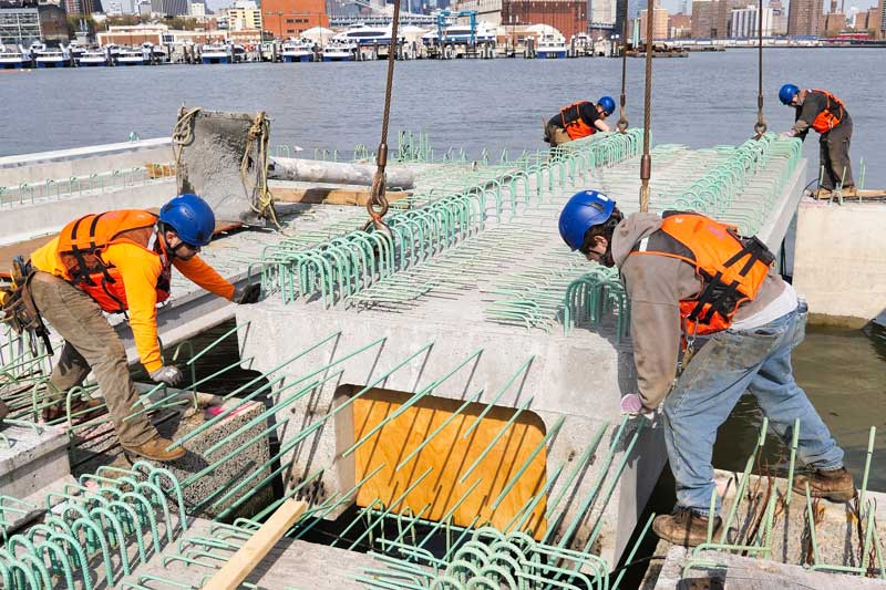 Trevcon workers positioning pre-cast pier deck